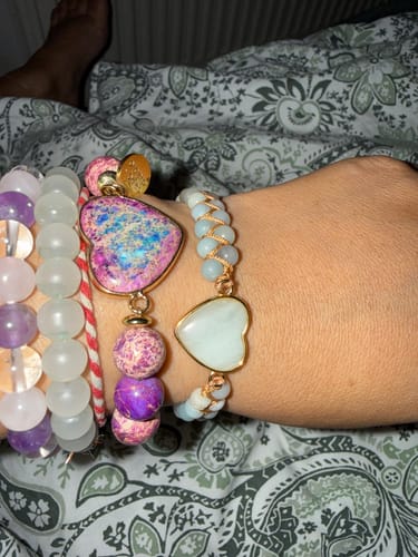 Customer's Amazonite Passion Bracelet with a heart-shaped charm worn on the wrist alongside other beaded bracelets.