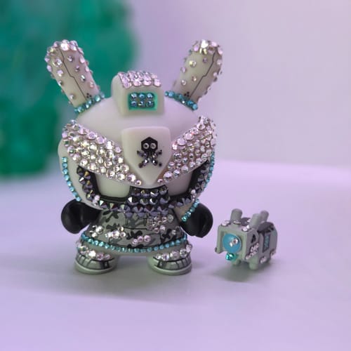 Customer's Crystal Grey Baby TEQ 63 Dunny figure adorned with sparkling crystals, accompanied by a small matching figurine.