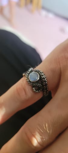 Reviewer's Ocean Blue ring with silver tentacle design on a finger.