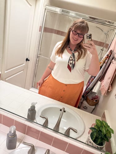 Customer's Flock Skinny Scarf featuring bird illustrations, styled around their neck in a bathroom mirror selfie.
