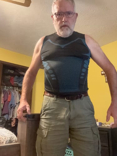 Customer's SlimFlex compression vest worn by a person, showing the black and blue design.