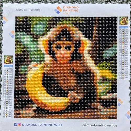 Customer's Diamond Painting Junger Affe showing a colorful monkey holding a banana with tiny, round sparkling stones.