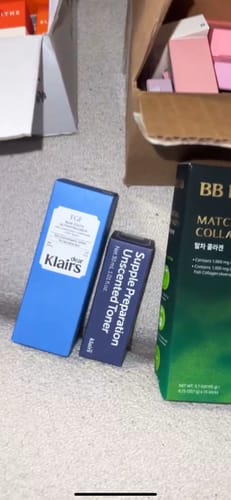 Customer's Supple Preparation Unscented Toner bottle alongside other skincare product boxes.
