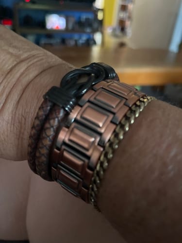 Customer's Copper Magnetic Bracelet on wrist alongside other bracelets