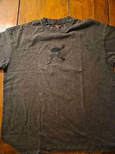 Customer's acid washed dark gray Zoro Wash Tee with a black embroidered sword and skull design on the chest.