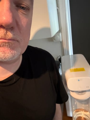 Reviewer's white H2RO Home countertop water purifier sitting on a counter.