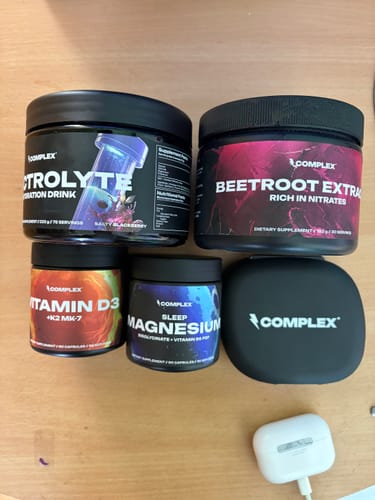 Customer's matte-black Pill box organizer alongside various Complex supplement containers.