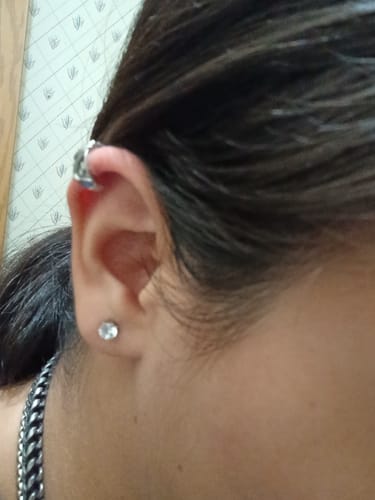 Customer's EAR CUFFS worn on the upper ear, showing a metallic design.