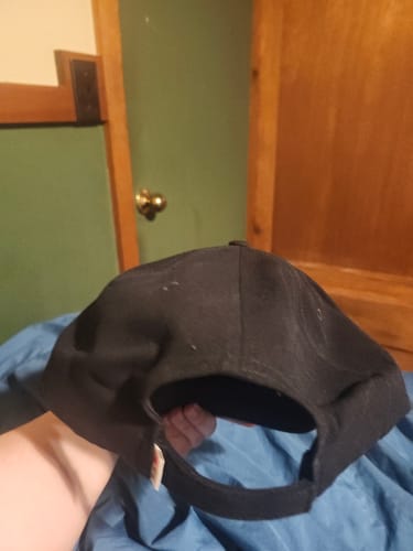 Customer's Big Relaxed Cap shown from the back, displaying the rear strap and simple black design.