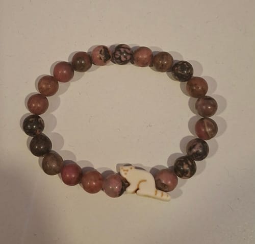 Customer's Dash Bracelet, a beaded elastic band featuring a small red panda charm on a plain background.