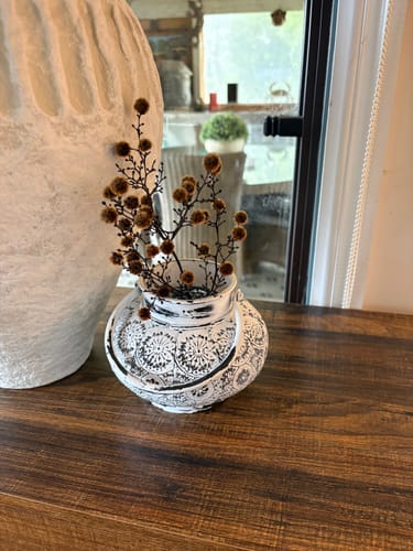 Customer's Soraya French Provincial Tea Light Lantern used as a vase for dried brown flowers on a wooden table.