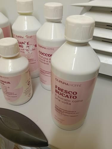 Reviewer's collection of Olimpia Home laundry perfumes, featuring the Fresco Bucato bottle prominently.