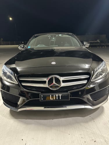 Customer's Mercedes C-Class with Flow Brackets number plate holder, parked at night.