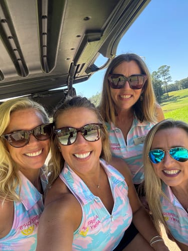 Customer's group of four people wearing Pastel Camo Women’s Sleeveless Golf Tank Top Shirts in a golf cart.