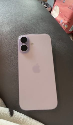 Customer's light purple iPhone 17 showing the back panel and dual camera lenses on a grey surface.