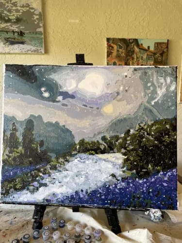 Customer's Custom Paint by Numbers kit showing a completed landscape painting on an easel.
