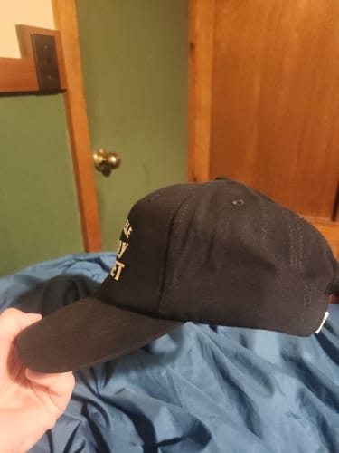 Customer's Big Relaxed Cap in a side profile view, highlighting the black fabric and curved bill.