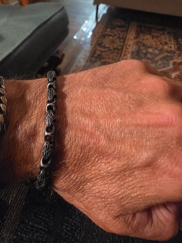 Customer's hand wearing a silver Byzantine Legacy Artisan Bracelet with interlocking links.