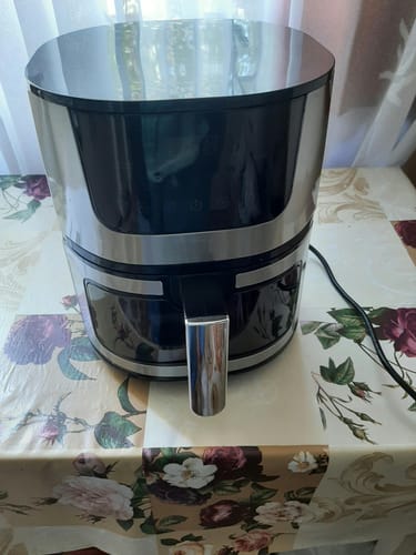 Customer's Air Fryer Novio Grill & Fry, a sleek silver and black kitchen appliance resting on a floral tablecloth.