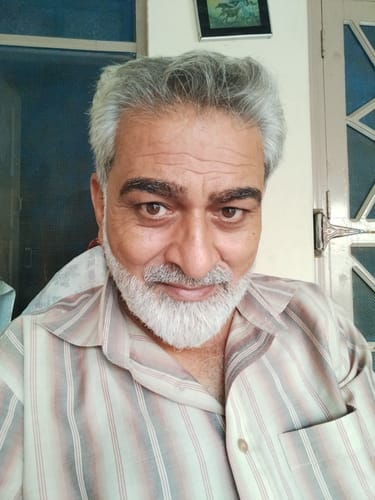 Customer's portrait view, appearing satisfied with The Royal Oud Collection fragrance.