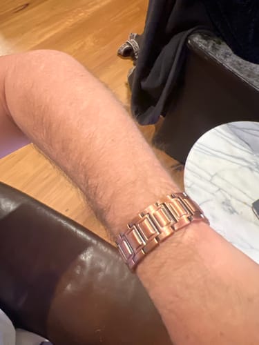 Customer's copper magnetic bracelet worn on a person's wrist, showing the sturdy metal link design.