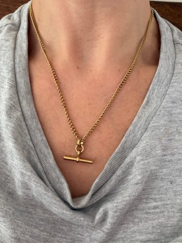 Reviewer's gold Piha T-Bar Necklace, showing the skinny curb chain and t-bar charm