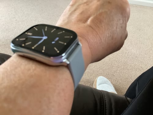 Reviewer's wrist wearing the smooth, gray Health Series Infinity Loop watch strap.