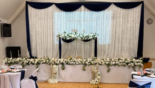 Customer's crushed velvet fabric used for elegant white and dark blue wedding décor draping.