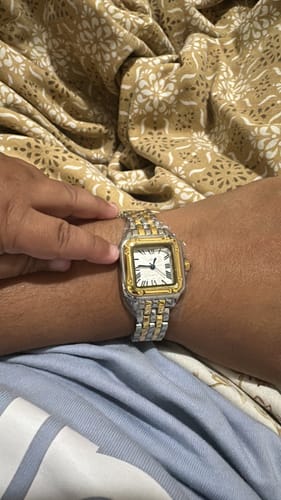 Customer's Grealy De Mains watch with gold and silver link band worn on wrist.