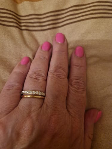 Customer's Rose Gold Full Glitz Ring worn on a finger, stacked with another simple gold ring.