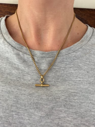 Customer's gold Piha T-Bar Necklace worn on the neck