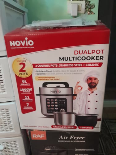Customer's Novio DualPot multicooker box showing images of the stainless steel and ceramic cooking pots.