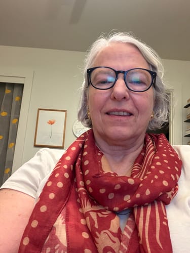 Customer's Dragon All-Season Scarf with red and beige polka dot pattern worn around neck.