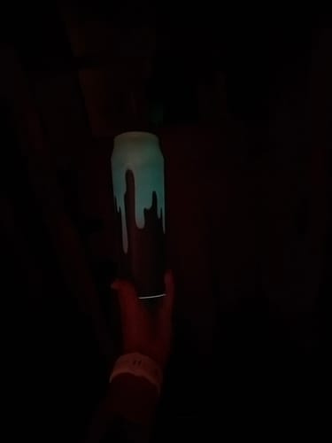 Customer's Bottle Buddy in dark room, showcasing the glowing Cosmic Drip pattern