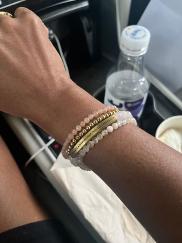 Customer's CUSTOM ENGRAVED WOMENS CHAIN BRACELET stack with gold and gemstone beads on wrist in vehicle