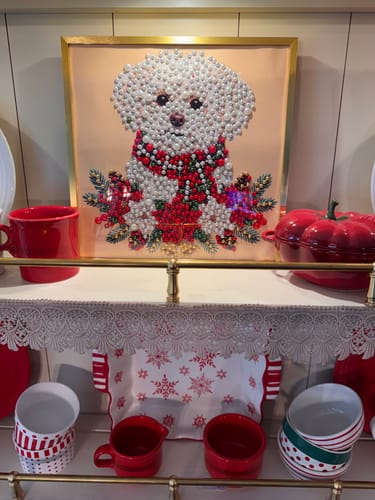 Customer's adorable wall art featuring a white dog with pearl-like details, displayed on a shelf with holiday decor.