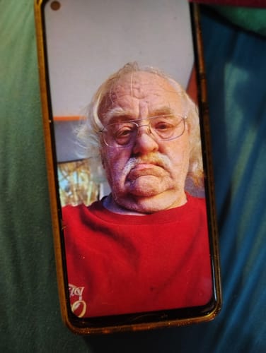 Customer's photo of a person wearing a red shirt, displayed on a smartphone screen.