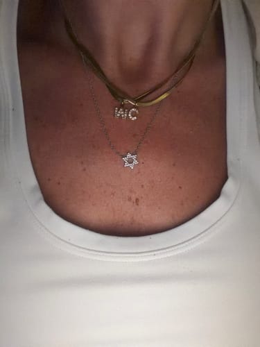 Customer's Melly Diamond Initial Herringbone Necklace worn as a layered gold chain with two custom letter charms.