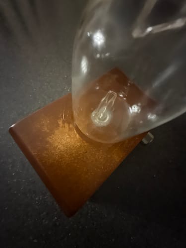 Reviewer's Aura Nebulizer wood base showing visible oil discoloration and damage.
