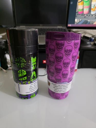 Reviewer's two Universal XL Midnight Manor cups sitting side by side, featuring green and purple skull patterns.