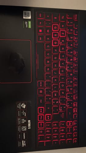 Customer's Acer Nitro 5 laptop keyboard with distinct red-backlit keys in a French layout.