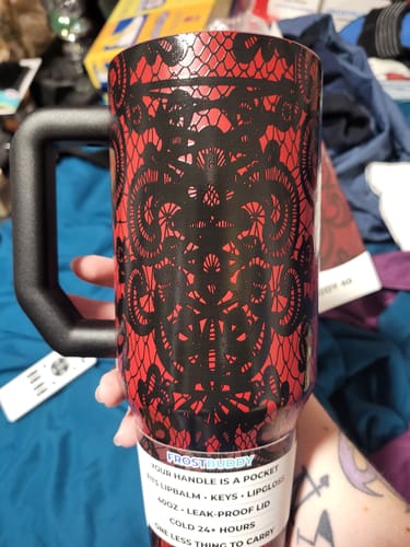 Customer's Thicc Buddy mug in red and black with a detailed lace pattern, held in hand with a product tag.