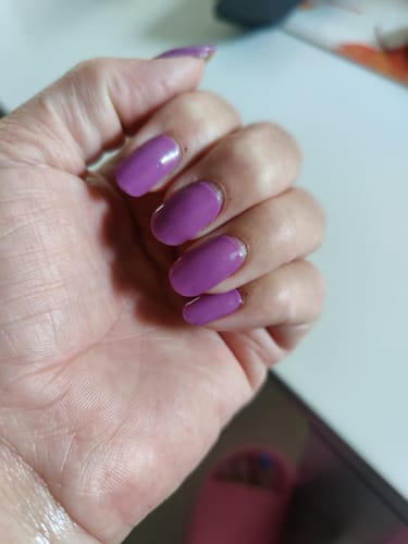 Customer's hand showing Sugarplum Song UV Gel Nail Wraps applied to fingernails in a vibrant violet shade.