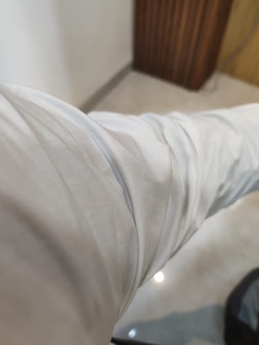 Customer's Uathayam white cotton shirt showing a close-up of the fabric texture on a sleeve