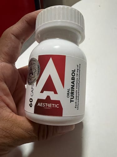 Customer's hand holding a white bottle of Aesthetic Labs Turinabol with a prominent A logo and label details.