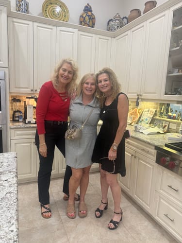 Customer's C black dress worn by a person standing in a kitchen with two other people.