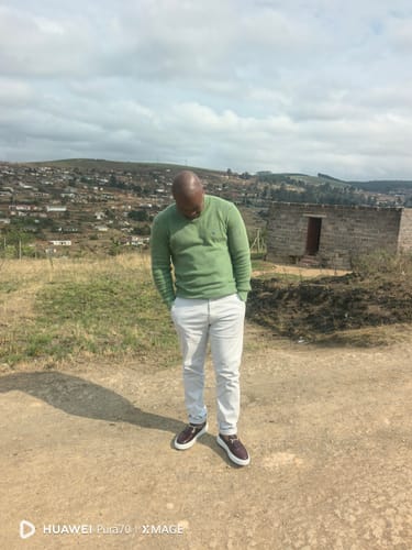 Customer's Lufiano Slip-On in burgundy worn outdoors by a person in a green sweater and light trousers.