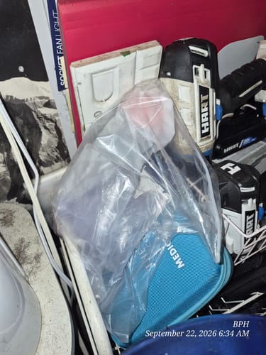 Customer's Adult Mask and Child Mask in a clear plastic bag, stored near power tools in a room.
