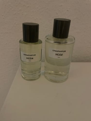 Customer's HCD2 and HCD4 fragrance bottles from CreaParfum standing on a white surface.