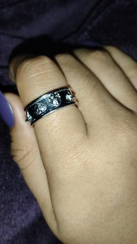 Reviewer's Psychedelic Love Ring worn on a finger, showing the silver metal band with engraved symbols.